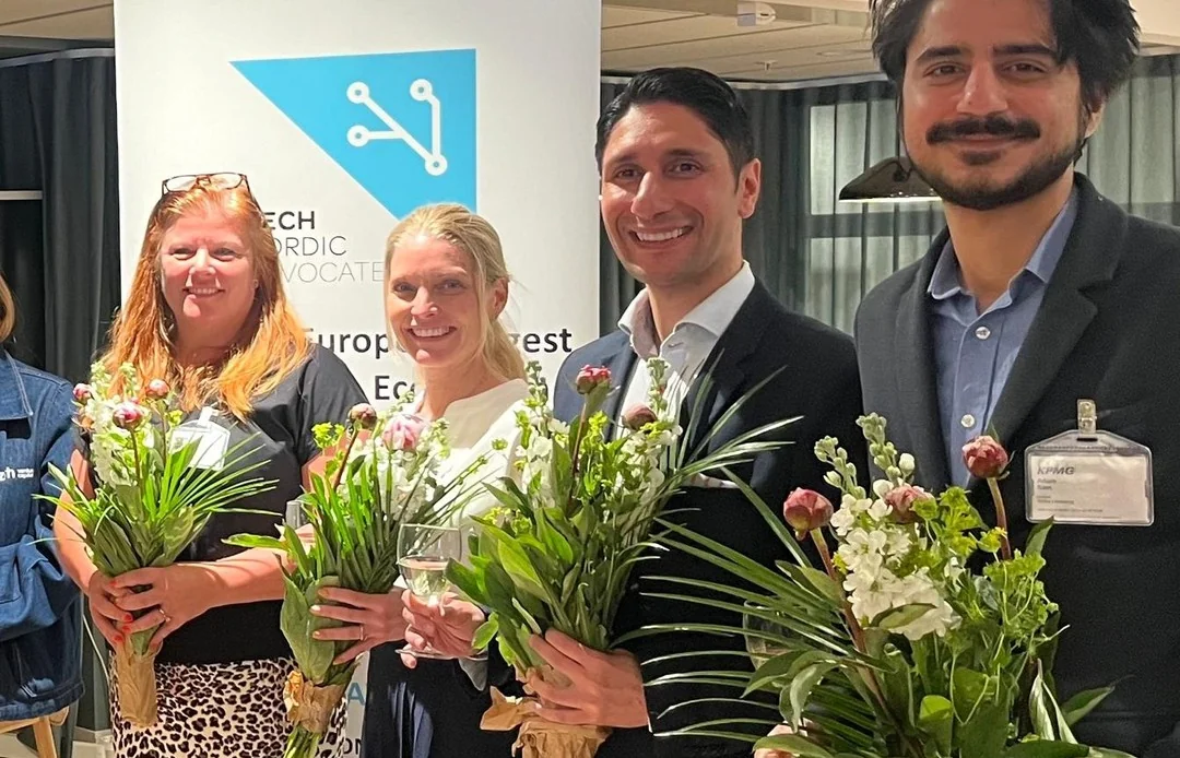 The Tech Nordic Advocates Stockholm pitch competition winners holding bouquets at KPMG’s office.